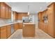 Charming kitchen with wooden cabinets, stainless steel appliances and an island, perfect for culinary enthusiasts at 1135 Parkview Sw Way, Lilburn, GA 30047