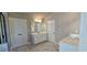 Bathroom featuring double sinks, modern lighting, and a separate water closet for added privacy at 3718 Southfield Ct, Loganville, GA 30052