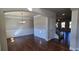Elegant dining room featuring hardwood floors, wainscoting, chandelier, and an archway, creating a sophisticated space at 3718 Southfield Ct, Loganville, GA 30052