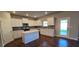 Bright kitchen featuring white cabinets, a gray backsplash, stainless steel appliances, and an island with quartz countertops at 3718 Southfield Ct, Loganville, GA 30052
