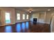 Bright living room featuring hardwood floors, a fireplace with built-ins, and a glass door leading to the backyard at 3718 Southfield Ct, Loganville, GA 30052