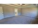 Spacious main bedroom featuring a tray ceiling, neutral color palette, and carpeted flooring at 3718 Southfield Ct, Loganville, GA 30052