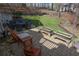Spacious backyard featuring a brick patio, lawn, and wooded views, with ample seating for relaxing and entertaining at 525 Hilliard Ct, Suwanee, GA 30024
