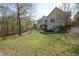 Exterior backyard view of the house featuring a spacious lawn and deck area at 525 Hilliard Ct, Suwanee, GA 30024