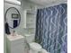 Modern bathroom with elegant vanity, sleek mirror, and stylish shower curtain, creating a calming retreat at 525 Hilliard Ct, Suwanee, GA 30024