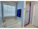 Bright bathroom featuring a large soaking tub with a shower at 525 Hilliard Ct, Suwanee, GA 30024