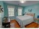 Bedroom featuring hardwood floors, natural lighting, and coastal decor at 525 Hilliard Ct, Suwanee, GA 30024