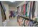 Walk-in closet with ample storage, multiple hanging rods, and well-organized shelving at 525 Hilliard Ct, Suwanee, GA 30024