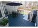 Inviting deck with outdoor seating and grill, perfect for entertaining with wooded views and nice decorations at 525 Hilliard Ct, Suwanee, GA 30024