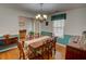 Traditional dining room boasts hardwood floors, chandelier, and decorative wainscoting at 525 Hilliard Ct, Suwanee, GA 30024