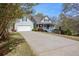 Attractive single-Gathering home with a welcoming front porch and a long driveway leading to a two-car garage at 525 Hilliard Ct, Suwanee, GA 30024