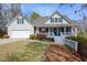 Charming home with a well-manicured lawn, inviting front porch, and an attached two-car garage at 525 Hilliard Ct, Suwanee, GA 30024