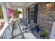 Inviting front porch featuring comfortable seating, decorative pillows, and a serene view of the outdoor surroundings at 525 Hilliard Ct, Suwanee, GA 30024
