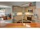 Open-concept kitchen with stainless appliances, granite counters, and eat-in bar area at 525 Hilliard Ct, Suwanee, GA 30024