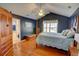 Spacious main bedroom with hardwood floors, fan, and ensuite bathroom access at 525 Hilliard Ct, Suwanee, GA 30024