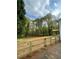 Fenced backyard with mature trees and green space, offering privacy and room for outdoor activities at 1110 Toonigh Rd, Canton, GA 30115