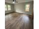 Light-filled bedroom with wood-look flooring and two large windows at 1110 Toonigh Rd, Canton, GA 30115