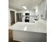 Updated kitchen with white cabinets, stainless steel appliances, and a breakfast bar with marbled countertops at 1110 Toonigh Rd, Canton, GA 30115