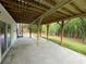 Covered patio overlooking a lush green backyard with mature trees at 1110 Toonigh Rd, Canton, GA 30115