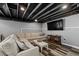 Finished basement with a comfortable L-shaped sofa and a large television at 116 Myrtle Rd, Woodstock, GA 30189