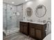 Bathroom showcasing a walk-in shower, double vanity, and decorative mirrors at 116 Myrtle Rd, Woodstock, GA 30189