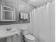Bright bathroom features a vanity, toilet and shower with a white curtain at 116 Myrtle Rd, Woodstock, GA 30189