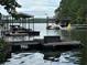 Boat dock featuring boat lift providing convenient water access and recreation on the lake at 116 Myrtle Rd, Woodstock, GA 30189