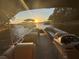 Interior view of a pontoon boat with plush seating, with a beautiful sunset view on the lake at 116 Myrtle Rd, Woodstock, GA 30189