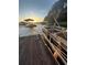 Pontoon boat docked at a private pier, offering a serene lake view at sunset at 116 Myrtle Rd, Woodstock, GA 30189