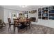 Open dining area with wood floors, fireplace, built-in shelving, and a large wooden table at 116 Myrtle Rd, Woodstock, GA 30189