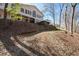 Exterior view of home with tall windows, elevated deck, and surrounding wooded landscape at 116 Myrtle Rd, Woodstock, GA 30189