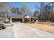 Classic white home with a dark roof, a spacious driveway, and a well-kept front yard at 116 Myrtle Rd, Woodstock, GA 30189