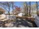 Charming home showcasing its exterior, a fenced yard, and a driveway surrounded by mature trees at 116 Myrtle Rd, Woodstock, GA 30189