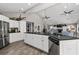 Open kitchen featuring white cabinets, stainless steel appliances, a large island, and a vaulted ceiling at 116 Myrtle Rd, Woodstock, GA 30189