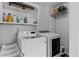 Functional laundry room features modern washer and dryer units with storage shelving at 116 Myrtle Rd, Woodstock, GA 30189