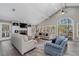 Spacious living room featuring vaulted ceilings, arched windows, and a cozy seating area at 116 Myrtle Rd, Woodstock, GA 30189