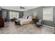 Spacious main bedroom featuring natural light, wood-look tile flooring, and neutral paint at 116 Myrtle Rd, Woodstock, GA 30189