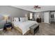 Spacious main bedroom with neutral paint, wood-look floors, and a furniture bench at the foot of the bed at 116 Myrtle Rd, Woodstock, GA 30189