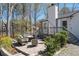 Comfortable outdoor patio with stone pavers, seating, and a view of mature trees at 116 Myrtle Rd, Woodstock, GA 30189