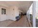 Exterior view of the porch with a seating area, brick floor, and white columns at 116 Myrtle Rd, Woodstock, GA 30189