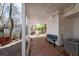 Exterior view of the porch with a seating area, brick floor, and white columns at 116 Myrtle Rd, Woodstock, GA 30189