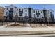 Townhomes with classic design elements, including a brick facade, black trim, and well-kept gated front yards at 633 Silva St # 133, Cumming, GA 30040