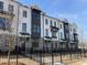 Well-maintained townhome exteriors boasting brick accents, black trim, and gated front yards at 633 Silva St # 133, Cumming, GA 30040