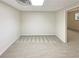 Finished basement area featuring neutral carpeting, and a door with potential for customization at 1336 Candlelite Ln, Snellville, GA 30078