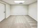 Spacious basement with neutral carpet and a door, offering potential for customization at 1336 Candlelite Ln, Snellville, GA 30078