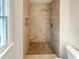 Close-up of walk-in shower features decorative tile and shower niche at 1336 Candlelite Ln, Snellville, GA 30078