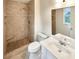 Bathroom featuring a tiled shower with a built-in seat and modern fixtures at 1336 Candlelite Ln, Snellville, GA 30078