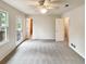 Bright bedroom featuring neutral carpet, a ceiling fan, and a door leading to the outside deck at 1336 Candlelite Ln, Snellville, GA 30078