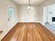 Bright dining room with wooden floors, a stylish light fixture, and a door leading to the backyard at 1336 Candlelite Ln, Snellville, GA 30078