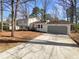 Charming two-story home with attached garage and inviting front yard landscaping at 1336 Candlelite Ln, Snellville, GA 30078